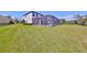 Spacious backyard features a screened-in pool, lush lawn, and a private fence, perfect for outdoor relaxation at 3020 Silva Wood Dr, Valrico, FL 33596