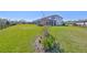 Beautifully landscaped backyard with a screened-in pool, manicured lawn, and vibrant plantings at 3020 Silva Wood Dr, Valrico, FL 33596