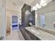 Well-lit bathroom with granite counters and dark cabinets at 3020 Silva Wood Dr, Valrico, FL 33596