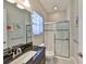 Bathroom featuring granite countertop, tiled shower with glass doors, and tile flooring at 3020 Silva Wood Dr, Valrico, FL 33596