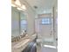 Neat bathroom featuring a tub/shower combo, modern fixtures, and clean, bright finishes at 3020 Silva Wood Dr, Valrico, FL 33596