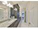 Bathroom featuring granite counters, dark cabinets, and ample lighting at 3020 Silva Wood Dr, Valrico, FL 33596