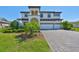 Charming two-story home featuring a three-car garage, well-manicured landscaping, and a paved driveway at 3020 Silva Wood Dr, Valrico, FL 33596