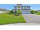 Elegant two-story home with a three-car garage, manicured landscaping, and a charming curb appeal at 3020 Silva Wood Dr, Valrico, FL 33596