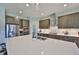 Stylish kitchen features a large center island, stainless steel appliances, ample cabinets, and modern lighting at 3020 Silva Wood Dr, Valrico, FL 33596