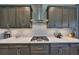 A well-equipped kitchen has stainless steel appliances, granite countertops, custom backsplash, and dark wooden cabinets at 3020 Silva Wood Dr, Valrico, FL 33596