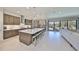 Modern kitchen featuring a large center island, stainless steel appliances, and ample cabinet space at 3020 Silva Wood Dr, Valrico, FL 33596