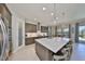 Bright, open kitchen with an island bar, stainless steel appliances, and seamless flow to the living area at 3020 Silva Wood Dr, Valrico, FL 33596