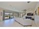 A bright living room with patio access, next to a staircase, showcases seamless indoor-outdoor living at 3020 Silva Wood Dr, Valrico, FL 33596