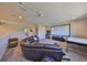 Spacious living room features a large leather sofa and a projector with a screen at 3020 Silva Wood Dr, Valrico, FL 33596