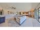 A bright living room with an open-concept layout, seamlessly connecting to the dining and kitchen areas at 3020 Silva Wood Dr, Valrico, FL 33596