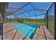 A refreshing pool and spa surrounded by brick pavers and an enclosed screen at 3020 Silva Wood Dr, Valrico, FL 33596