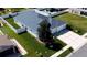 Well-maintained single-story home with white fence, lush lawn, and two-car garage at 3215 Coconut Grove Rd, Land O Lakes, FL 34639