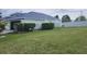 View of the backyard with bushes and a white vinyl fence at 3215 Coconut Grove Rd, Land O Lakes, FL 34639