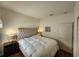 Serene bedroom with tufted headboard, bedside tables, lamps, and neutral color palette at 3215 Coconut Grove Rd, Land O Lakes, FL 34639