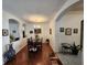 Bright dining room with a large table, hardwood floors, and archway to other rooms at 3215 Coconut Grove Rd, Land O Lakes, FL 34639