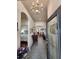 Inviting foyer with tiled floor, decorative lighting, and an open view into other rooms at 3215 Coconut Grove Rd, Land O Lakes, FL 34639