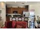 Inviting kitchen featuring wood cabinets, appliances, breakfast bar with seating, and living space at 3215 Coconut Grove Rd, Land O Lakes, FL 34639