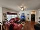 Cozy living room with hardwood floors, a ceiling fan, and plenty of natural light creating a welcoming atmosphere at 3215 Coconut Grove Rd, Land O Lakes, FL 34639
