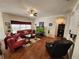 Bright living room with hardwood floors, large windows, and a comfortable seating arrangement for relaxation at 3215 Coconut Grove Rd, Land O Lakes, FL 34639