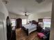Brightly lit main bedroom featuring hardwood floors, a ceiling fan and matching dressers at 3215 Coconut Grove Rd, Land O Lakes, FL 34639