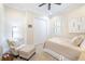 Bedroom featuring a closet, plantation shutters and a soft chair with ottoman at 32409 Silvercreek Way, Wesley Chapel, FL 33545