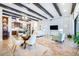 Inviting living room featuring a bar area, tile floors, and wood beam ceilings at 32409 Silvercreek Way, Wesley Chapel, FL 33545