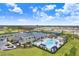 An aerial view showcases the community pool, clubhouse, tennis courts, playground, and other community amenities at 32423 Rosewood Meadow Ln, Wesley Chapel, FL 33543