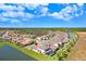 Aerial view of a home situated on a waterfront lot, community and lush surroundings at 32423 Rosewood Meadow Ln, Wesley Chapel, FL 33543