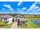 Aerial view of a two-story home with a screened-in pool area, near a pond and with beautiful landscaping at 32423 Rosewood Meadow Ln, Wesley Chapel, FL 33543