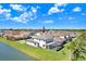 Aerial view of a two-story home with a screened-in pool area, near a pond and beautifully landscaped yard at 32423 Rosewood Meadow Ln, Wesley Chapel, FL 33543