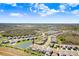 Aerial view of home on a waterfront lot with a screened in pool and a stunning view at 32423 Rosewood Meadow Ln, Wesley Chapel, FL 33543