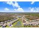Aerial view of property in a community, located on a waterfront lot and lush surroundings at 32423 Rosewood Meadow Ln, Wesley Chapel, FL 33543