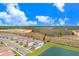 Aerial view of home on a waterfront lot with a screened in pool and a beautiful view at 32423 Rosewood Meadow Ln, Wesley Chapel, FL 33543