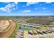 Expansive aerial view of the property with a picturesque lake view and surrounding community at 32423 Rosewood Meadow Ln, Wesley Chapel, FL 33543