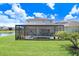 View of a well-maintained backyard with a screened in pool and outdoor living area at 32423 Rosewood Meadow Ln, Wesley Chapel, FL 33543