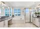 Bright bathroom with double vanity, shower, tub and decorative lighting at 32423 Rosewood Meadow Ln, Wesley Chapel, FL 33543