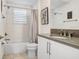 Bathroom featuring a vanity, toilet, and a shower-tub combo with a curtain at 32423 Rosewood Meadow Ln, Wesley Chapel, FL 33543