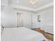 Spacious bedroom features trey ceiling, chandelier, wood floors, and ample natural light at 32423 Rosewood Meadow Ln, Wesley Chapel, FL 33543