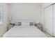 Bedroom with a mirror, white walls, and white furnishings at 32423 Rosewood Meadow Ln, Wesley Chapel, FL 33543