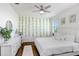 Airy bedroom with wood flooring, white furnishings, and an elegant ceiling fan at 32423 Rosewood Meadow Ln, Wesley Chapel, FL 33543
