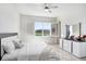 Light and airy bedroom features a view of the lake at 32423 Rosewood Meadow Ln, Wesley Chapel, FL 33543