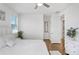 Bright bedroom featuring a ceiling fan, hardwood floors, and white furniture at 32423 Rosewood Meadow Ln, Wesley Chapel, FL 33543