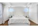 Bright bedroom featuring a luxurious bed with tufted headboard, stylish lighting, and sleek glass bedside tables at 32423 Rosewood Meadow Ln, Wesley Chapel, FL 33543