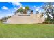 Elegant entrance to Winding Ridge featuring a tiered fountain, lush landscaping and decorative metalwork at 32423 Rosewood Meadow Ln, Wesley Chapel, FL 33543