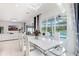 Dining area with an open-concept living space and a view of the pool through the large windows at 32423 Rosewood Meadow Ln, Wesley Chapel, FL 33543
