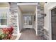 Inviting entryway with stone accents and a double door entry at 32423 Rosewood Meadow Ln, Wesley Chapel, FL 33543