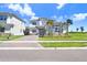 Charming two-story home with stone accents, a brick paved driveway, and beautifully landscaped front yard at 32423 Rosewood Meadow Ln, Wesley Chapel, FL 33543