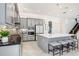 Modern kitchen features grey cabinets, stainless appliances, large island with seating and decorative backsplash at 32423 Rosewood Meadow Ln, Wesley Chapel, FL 33543