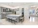 Stylish kitchen featuring gray cabinetry, a large island with seating, and modern appliances at 32423 Rosewood Meadow Ln, Wesley Chapel, FL 33543
